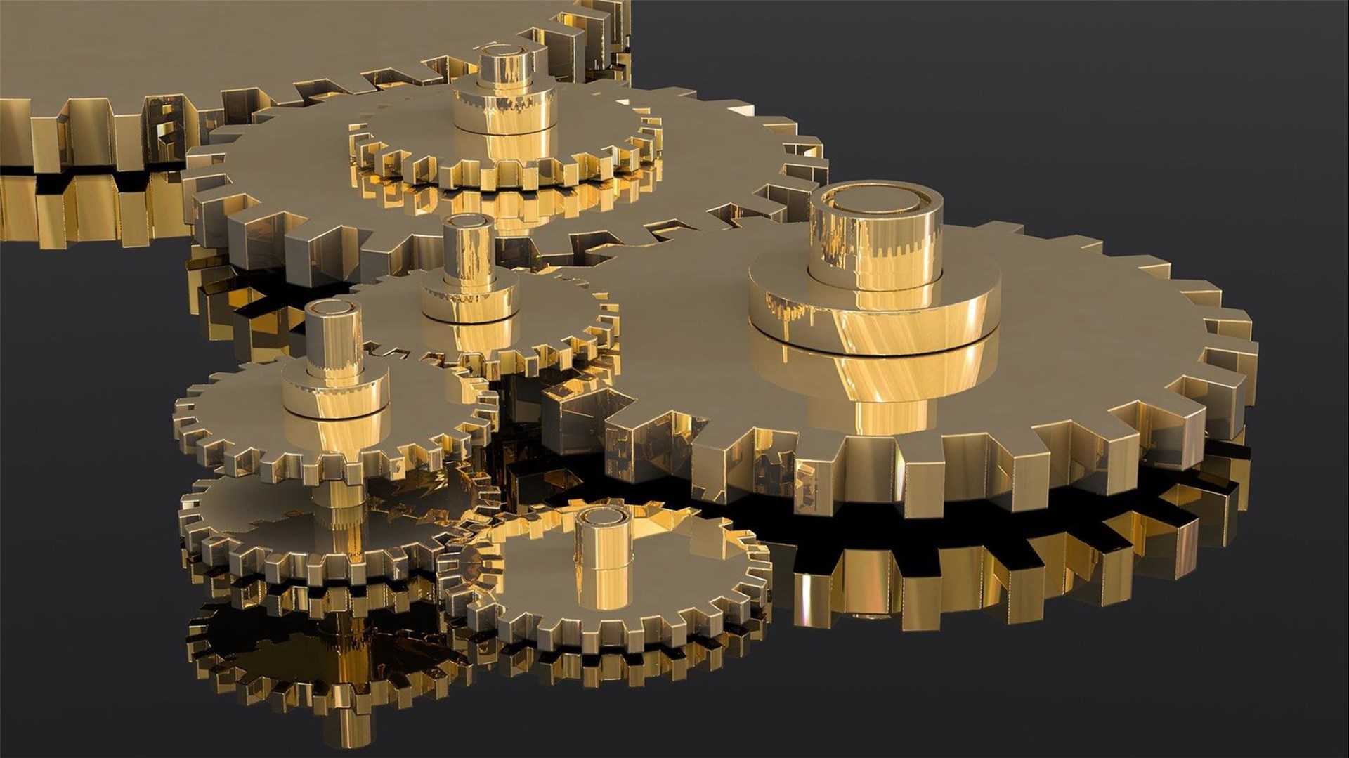 Zwei goldene Zahnräder greifen ineinander