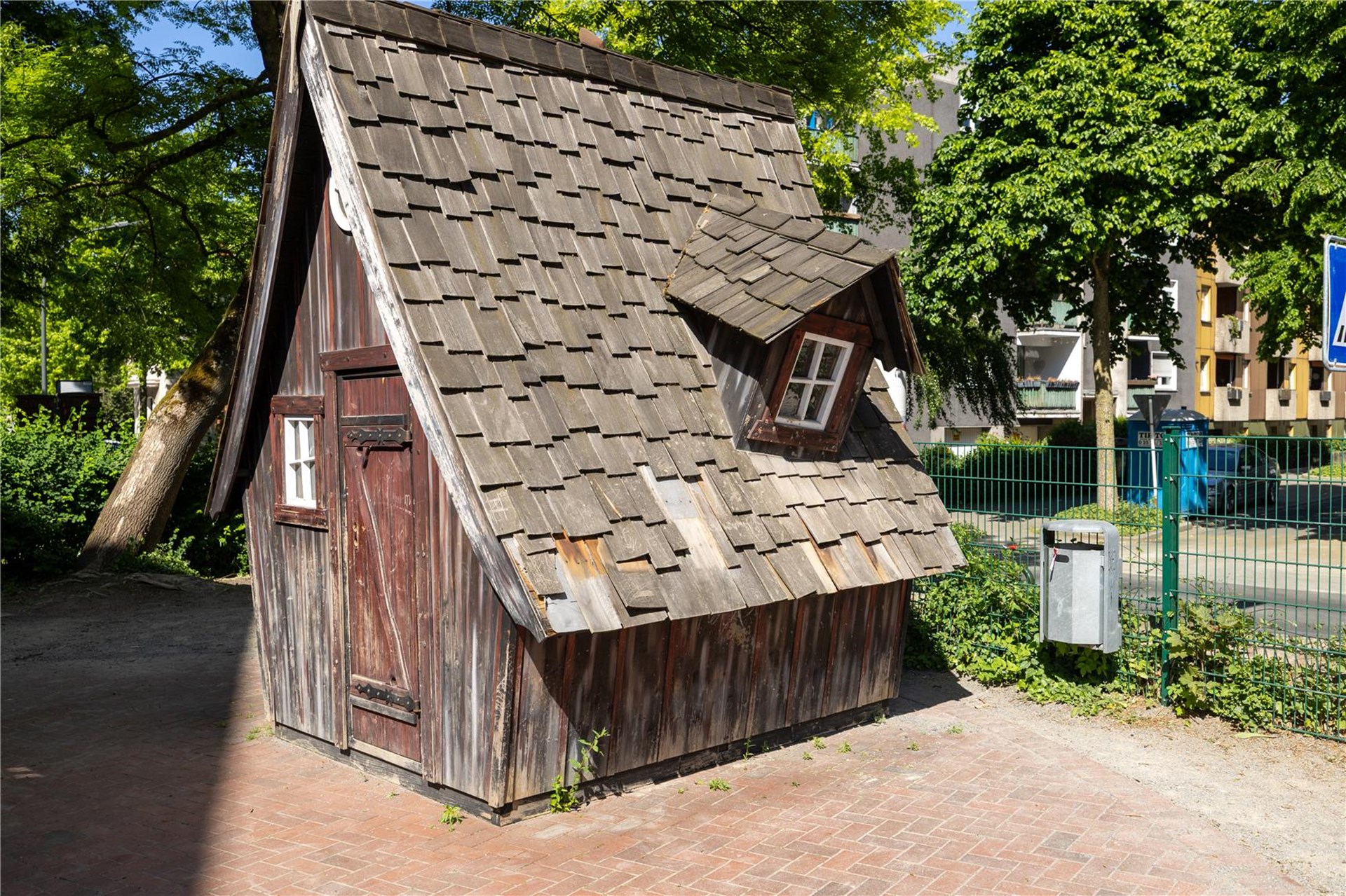 Ein kleines Holzhaus, das wie ein Hexenhaus wirkt.